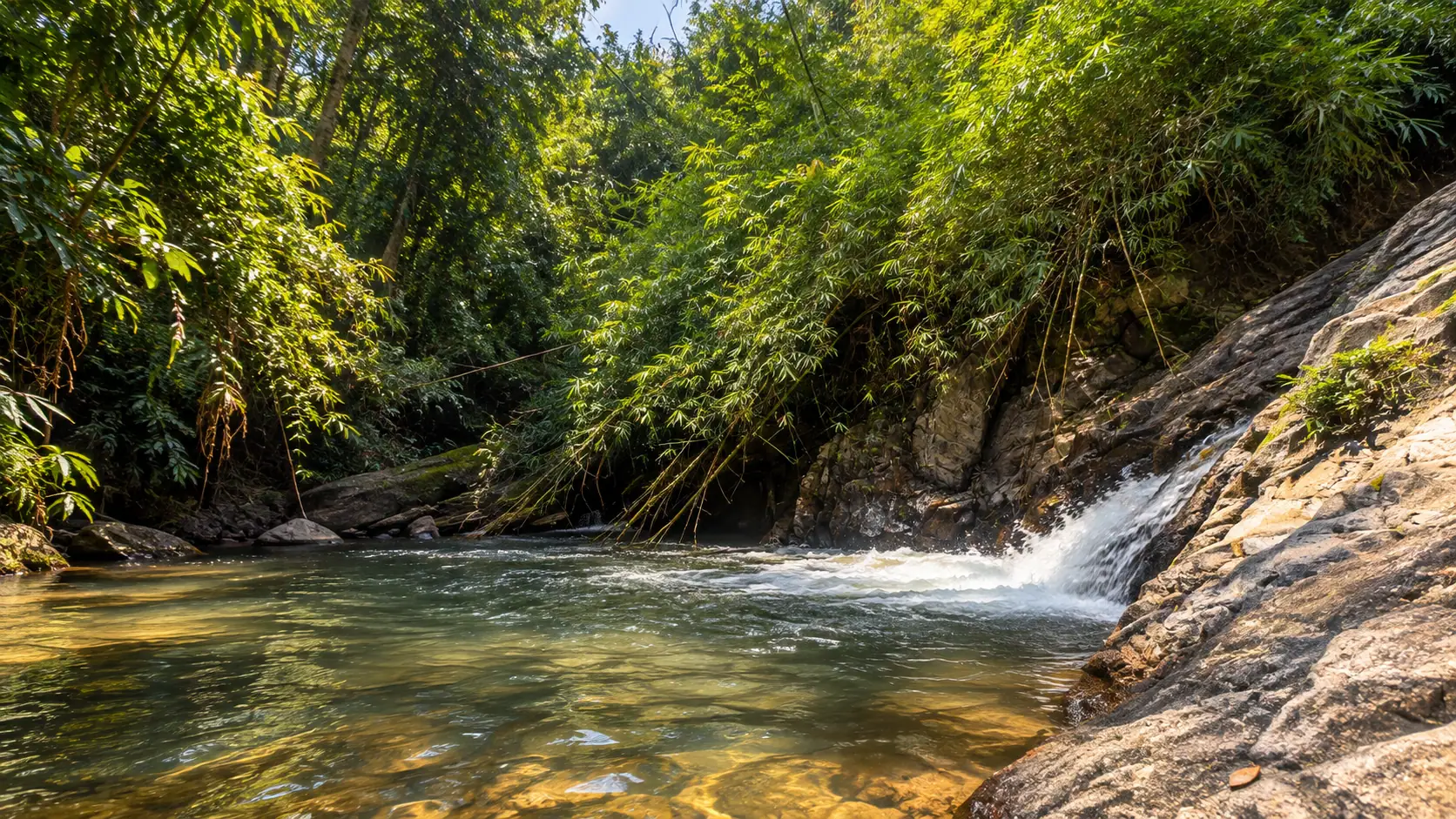 The natural waterfall near the estate, a clear pool below