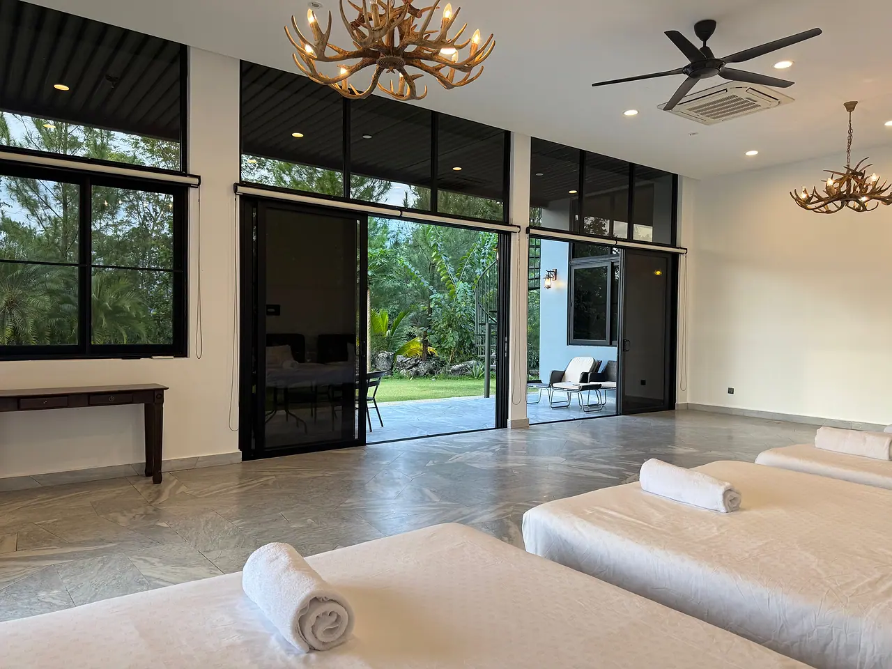 The family room beds, with glass doors to the garden and the trees