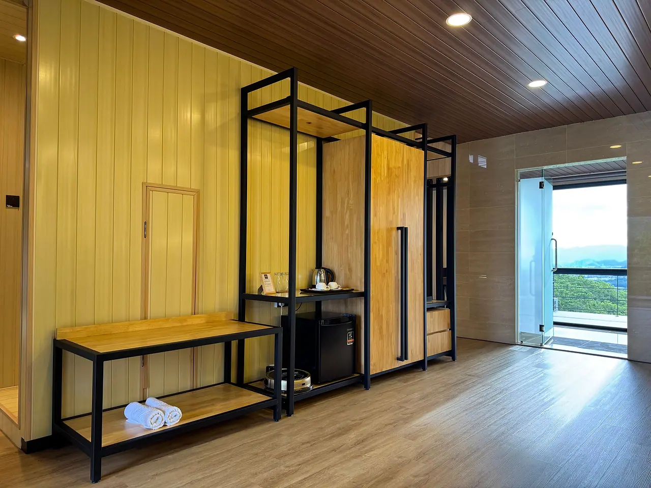 The penthouse walk-in wardrobe, with open steel-framed shelving and a window to the hills