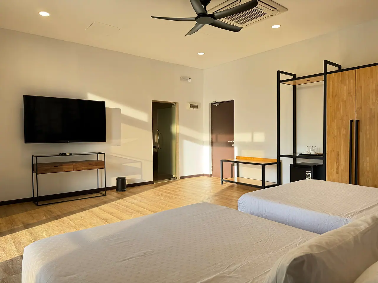 Two queen beds, a TV and a console desk in the deluxe two-queen room