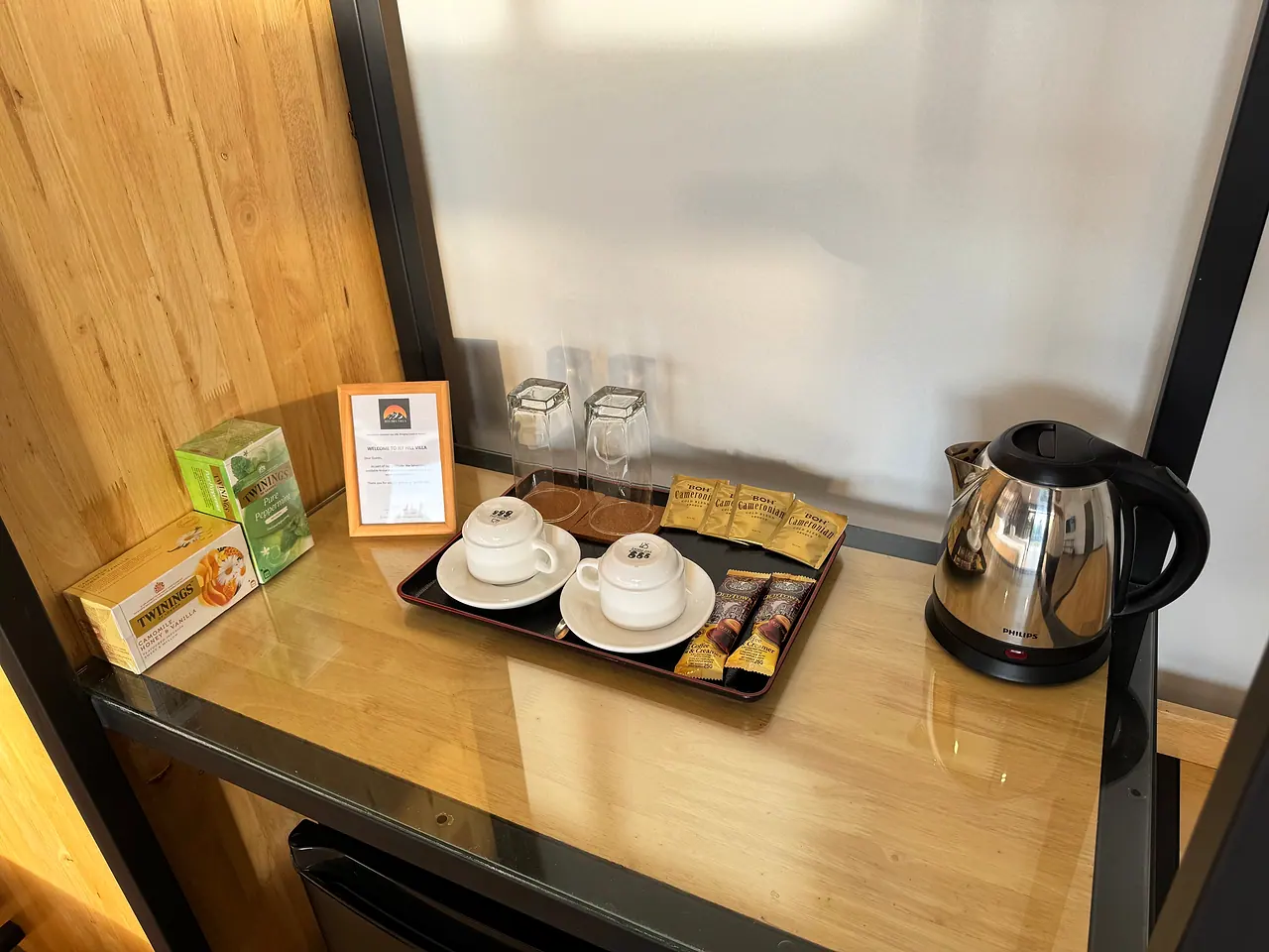 An in-room kettle with cups, tea and coffee